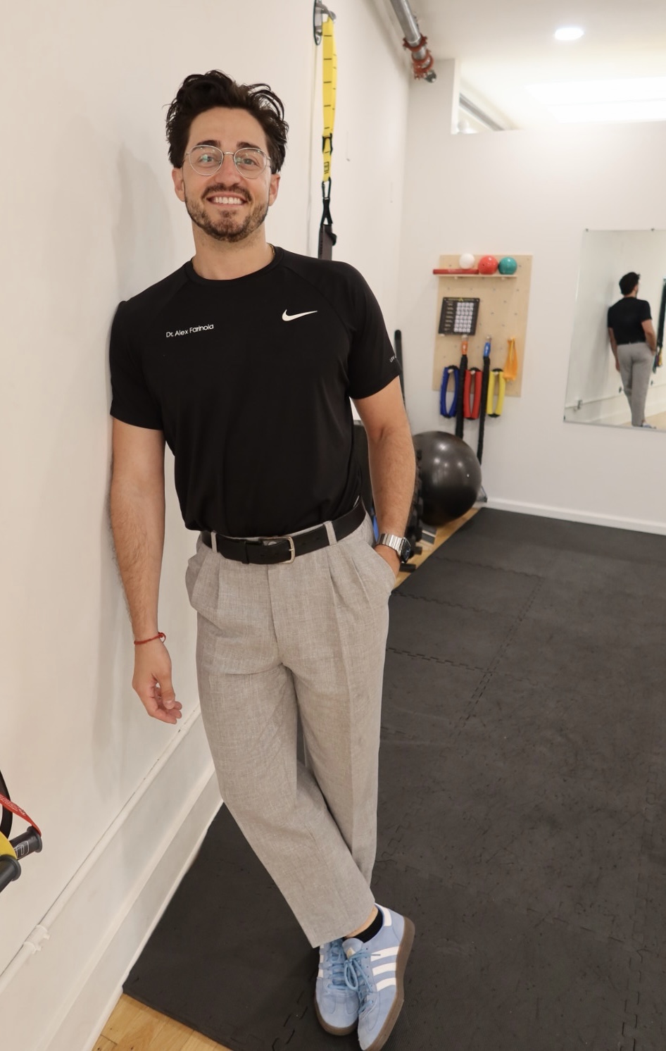 Alex Farinola smiling in a rehabilitation studio